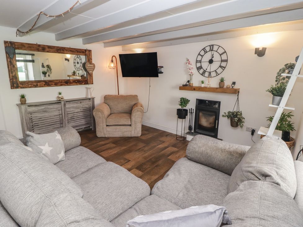 A living room with a sofa and an armchair at 41 St. James Street Narberth