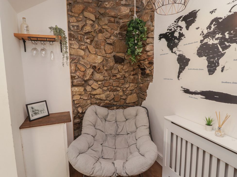 A sitting area with a chair and decorative items at 41 St. James Street Narberth