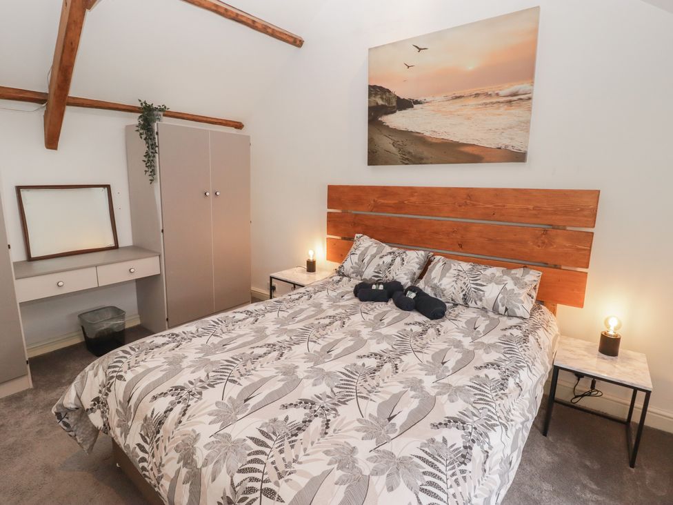 A bedroom with a bed and wardrobe at 41 St. James Street, Narberth