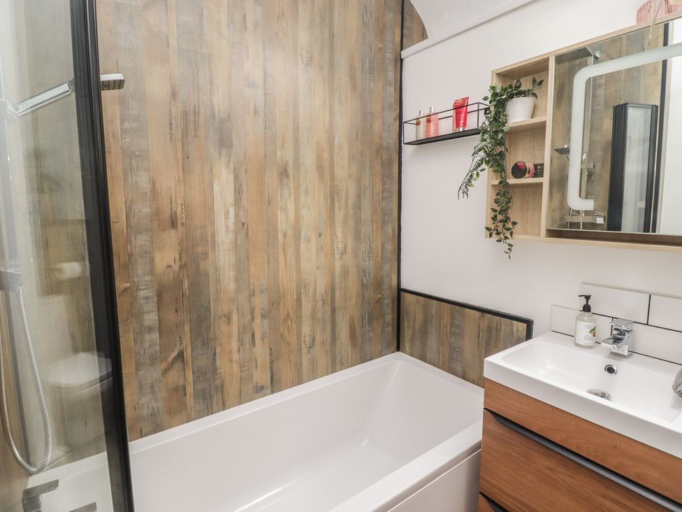 A bathroom with a bathtub and shower at 41 St. James Street Narberth