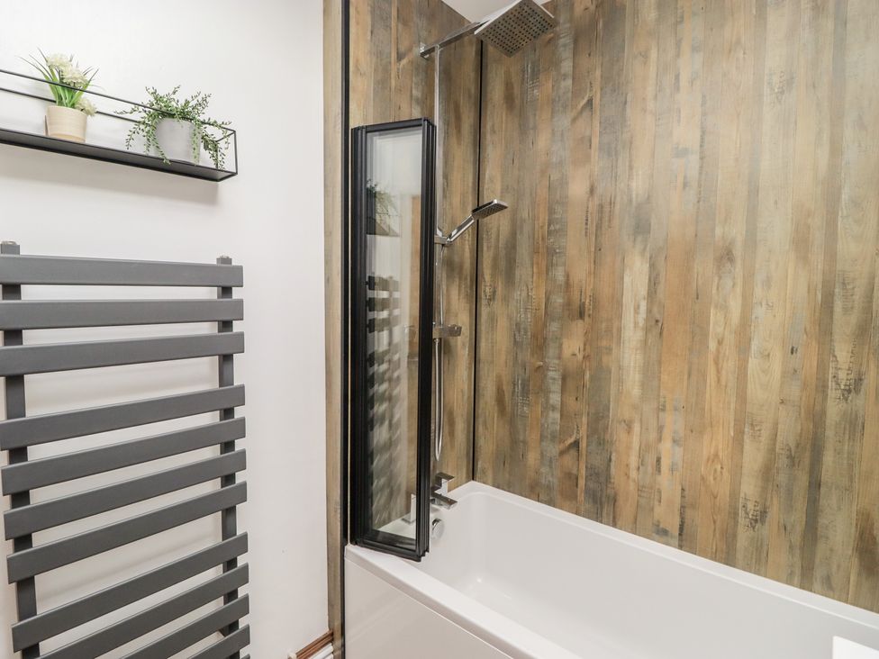 A bathroom with a bathtub and shower at 41 St. James Street, Narberth