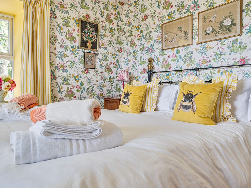 A bedroom with a bed and pillows at Bodior Lodge in Rhoscolyn
