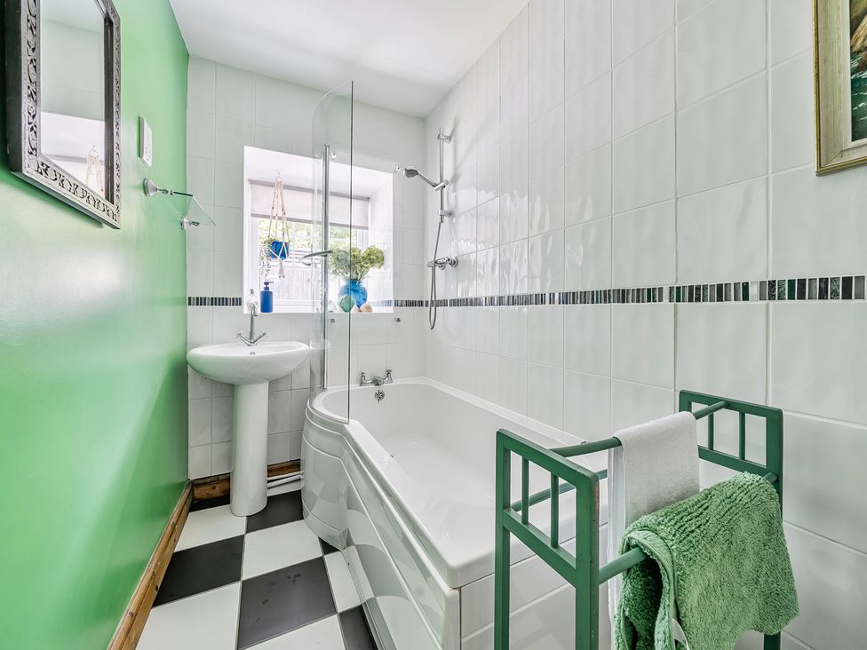 A bathroom with a bathtub, sink, and shower at Bodior Lodge in Rhoscolyn