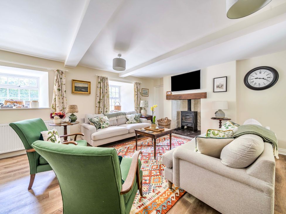 A living room with a sofa and armchairs at Bodior Garden Cottage in Rhoscolyn