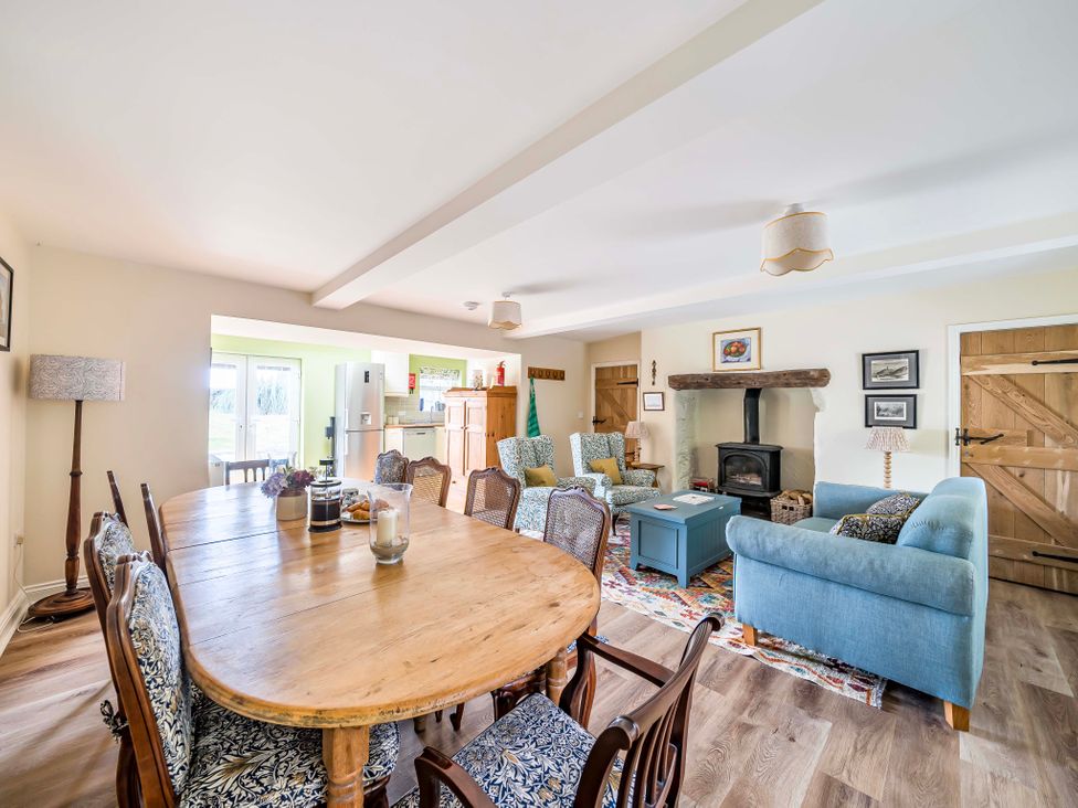 A dining room with a table and chairs at Bodior Garden Cottage in Rhoscolyn