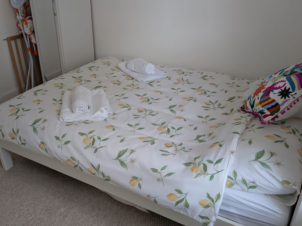 A bedroom with a bed and towels at 1A Market Street Buxton