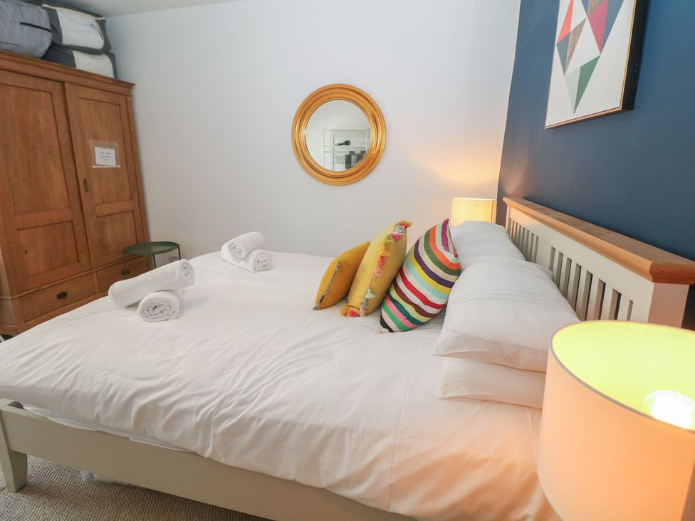 A bedroom with a bed and wardrobe at Cosy Cottage in Buxton
