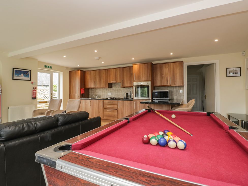 A game room featuring a pool table and kitchen area at Whimhowe Windermere