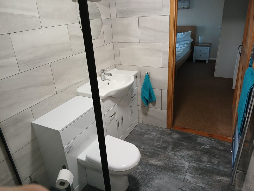 A bathroom with a toilet and sink at The Dairy Barn in Camelford