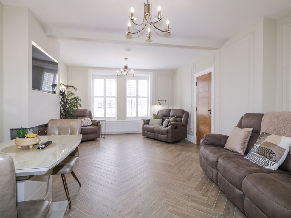 A living room with sofas and a table at 41 Church view in Portstewart