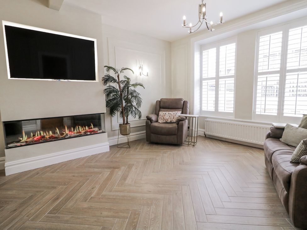 A living room with a television and electric fireplace at 41 Church view in Portstewart