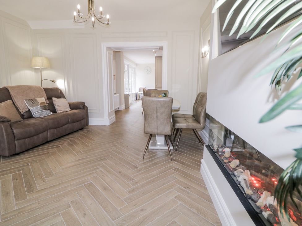 A living room with a sofa and dining area at 41 Church view in Portstewart