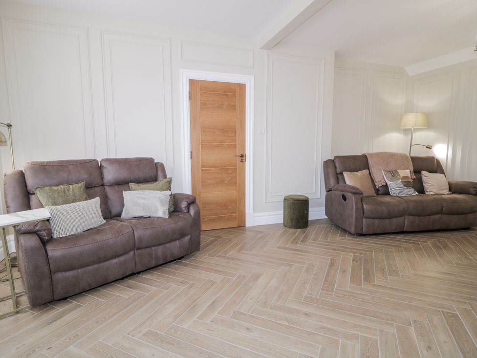 A living room with two sofas and a lamp at 41 Church view in Portstewart