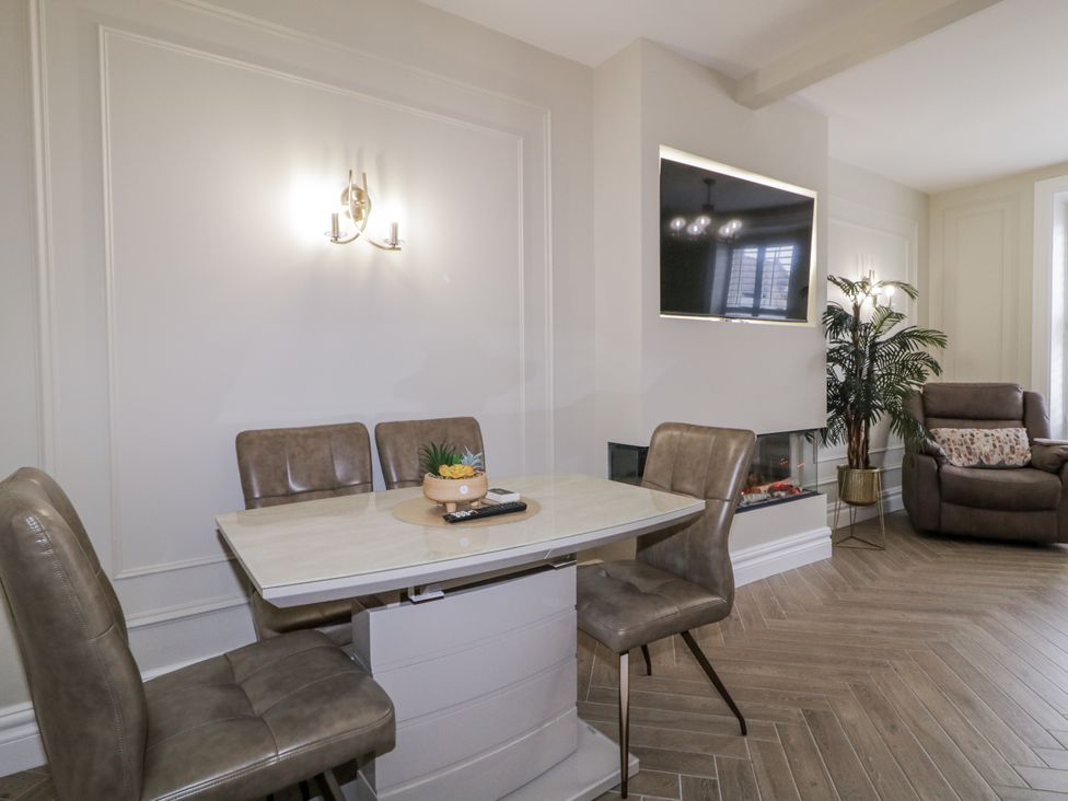 A dining room with a table and chairs at 41 Church view in Portstewart