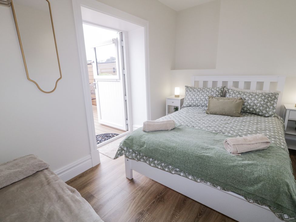 A bedroom with a bed and a door at 41 Church view Portstewart