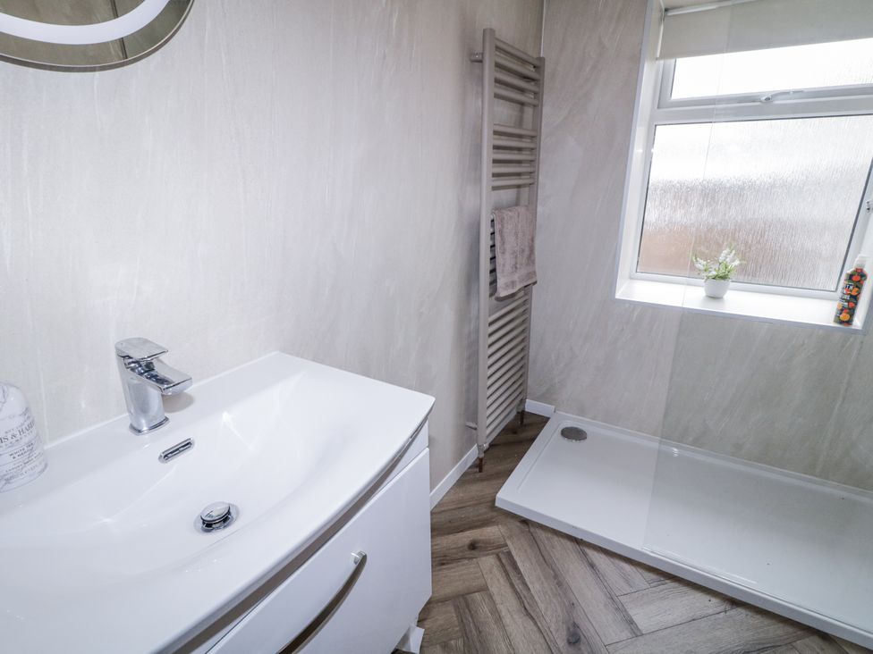 A bathroom with a sink, radiator, and shower tray at 41 Church view Portstewart