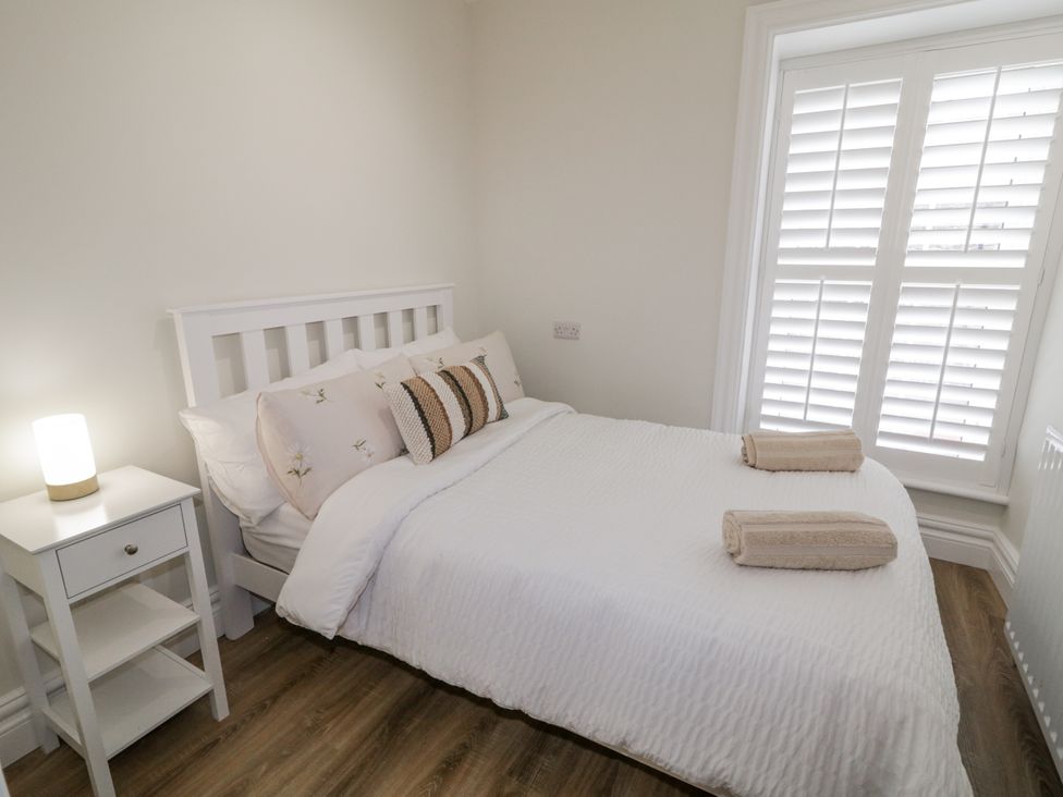 A bedroom with a double bed and a nightstand at 41 Church view in Portstewart