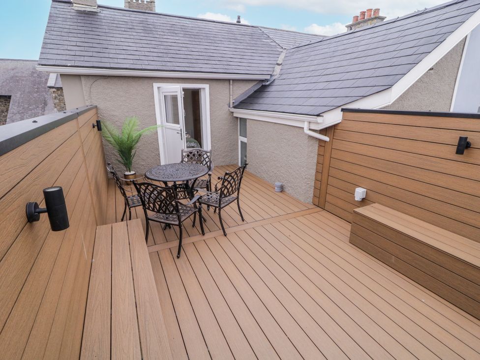 An outdoor deck with a table and chairs at 41 Church view, Portstewart