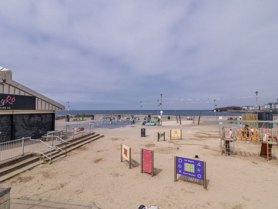 A playground and beach area with a building at 41 Church view Portstewart