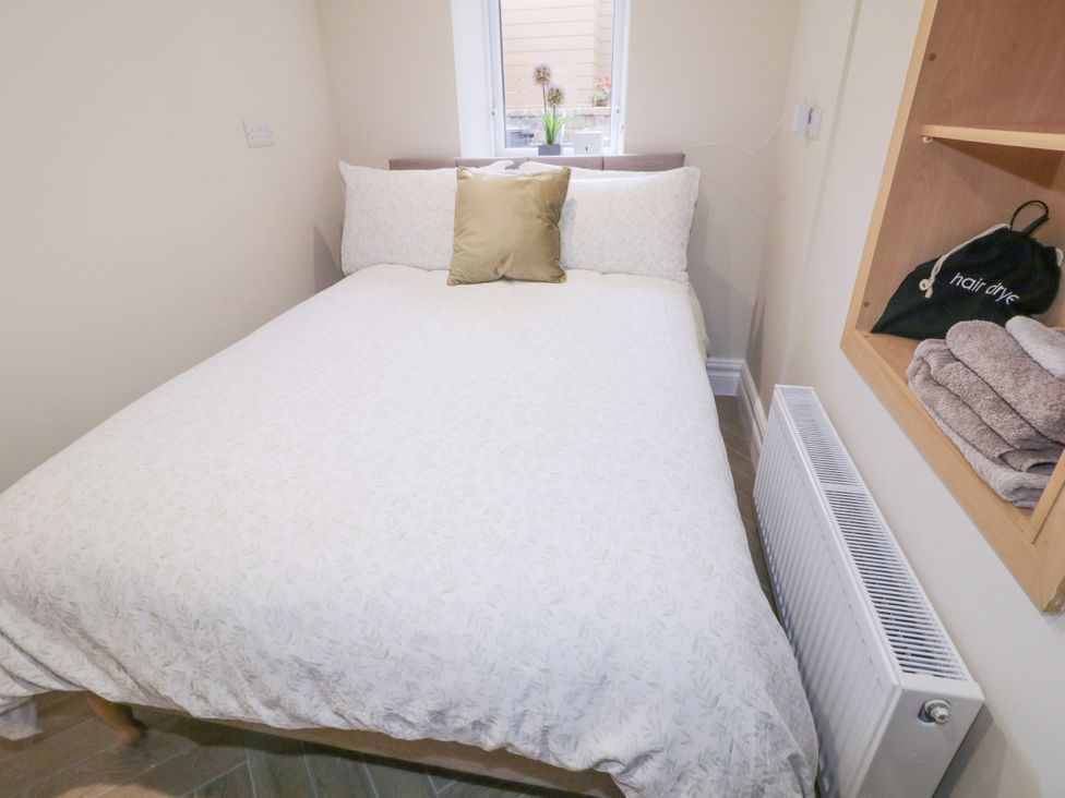 A bedroom with a bed and shelves at 41 Church view, Portstewart, County Londonderry