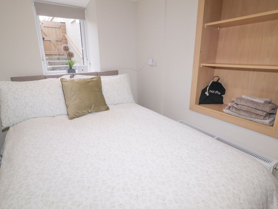 A bedroom with a bed and shelves at 41 Church view, Portstewart, County Londonderry