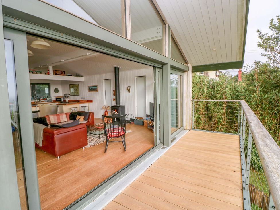 A living room with a sofa and coffee table at Green Shutters in Freshwater East near Lamphey
