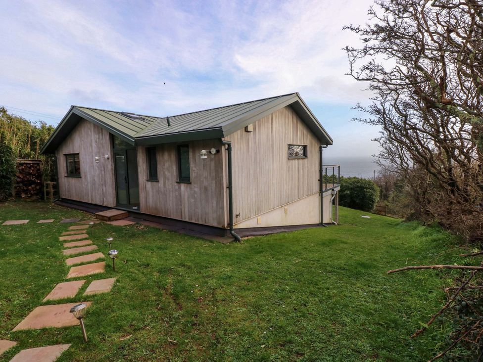 A house with a garden and pathway at Green Shutters Freshwater East near Lamphey