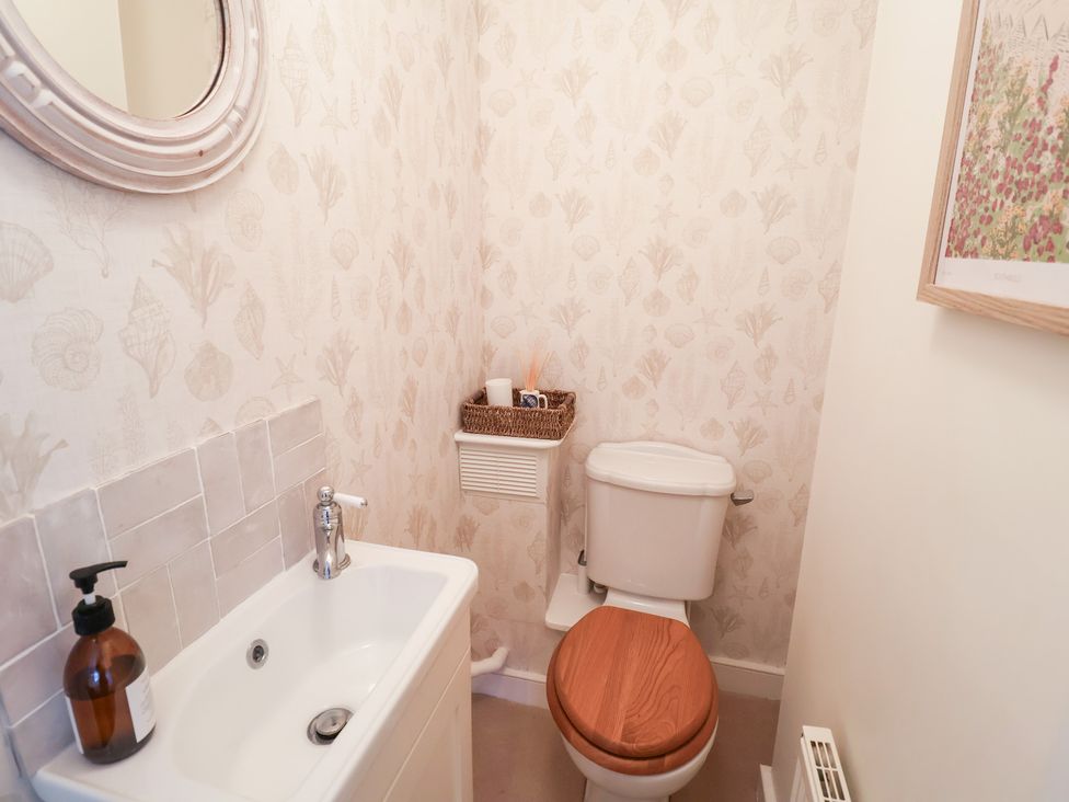 A bathroom with a sink and a toilet at Victoria Cottage (4 East Green) Southwold