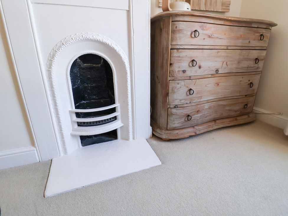 A fireplace and a chest of drawers at Victoria Cottage (4 East Green) Southwold