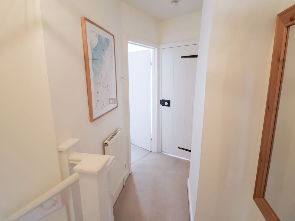 A hallway with a radiator and a picture at Victoria Cottage (4 East Green) Southwold