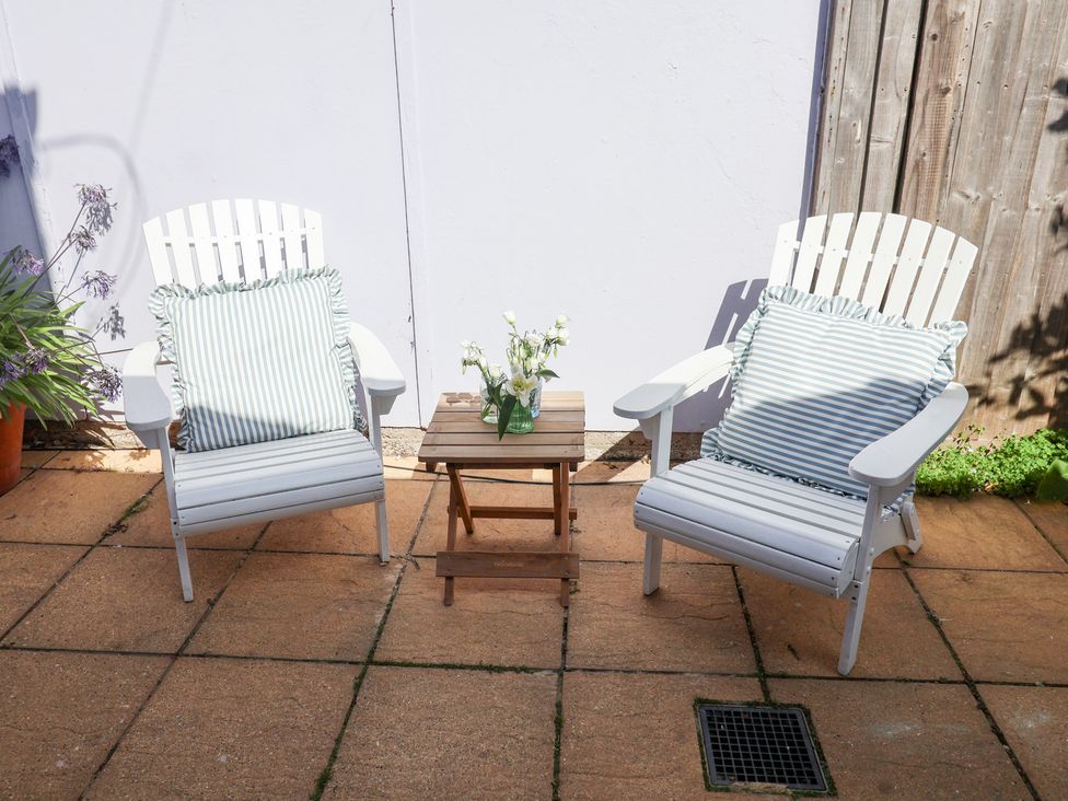 A seating area with two chairs and a table at Victoria Cottage (4 East Green) Southwold