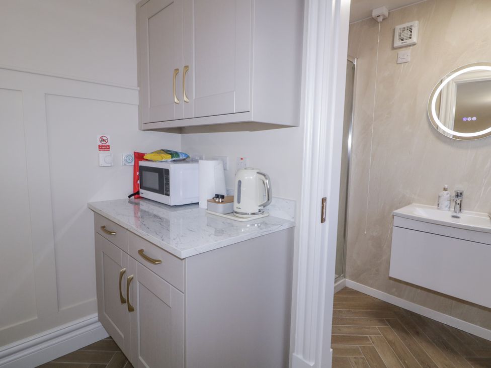 A kitchenette with a microwave and kettle at Church Studio Portstewart