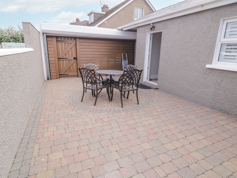 An outdoor patio with a table and chairs at Church Studio in Portstewart
