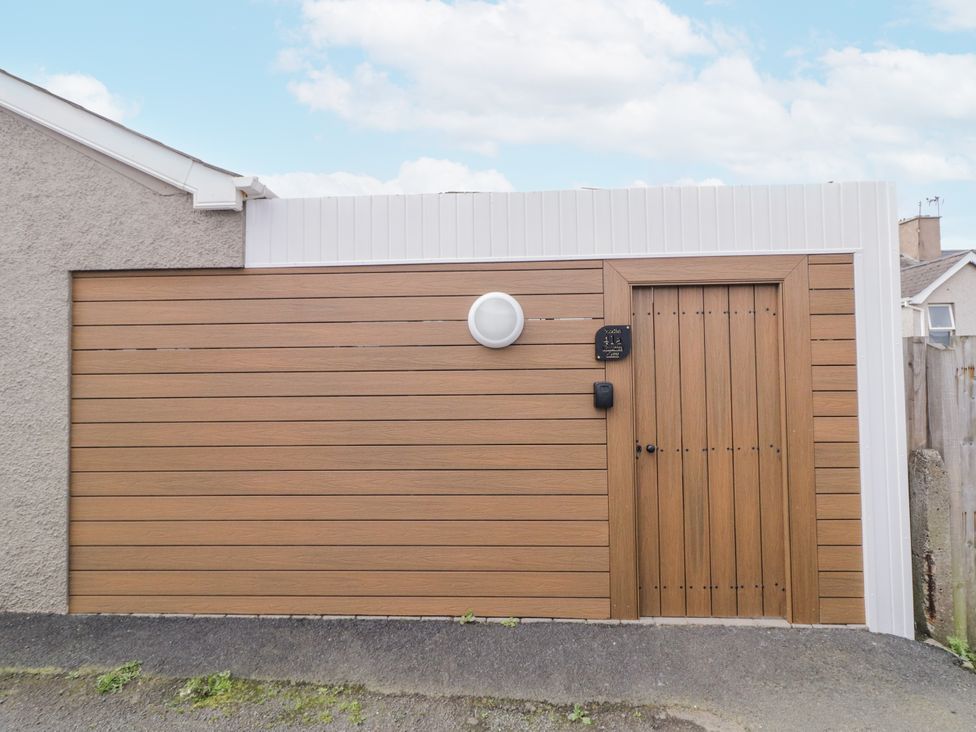 An entrance with a wooden door and light fixture at Church Studio, Portstewart, County Londonderry