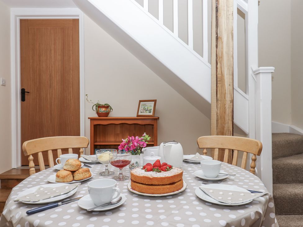 A dining room with a table set for tea at Aunty Junes Cottage in Okehampton