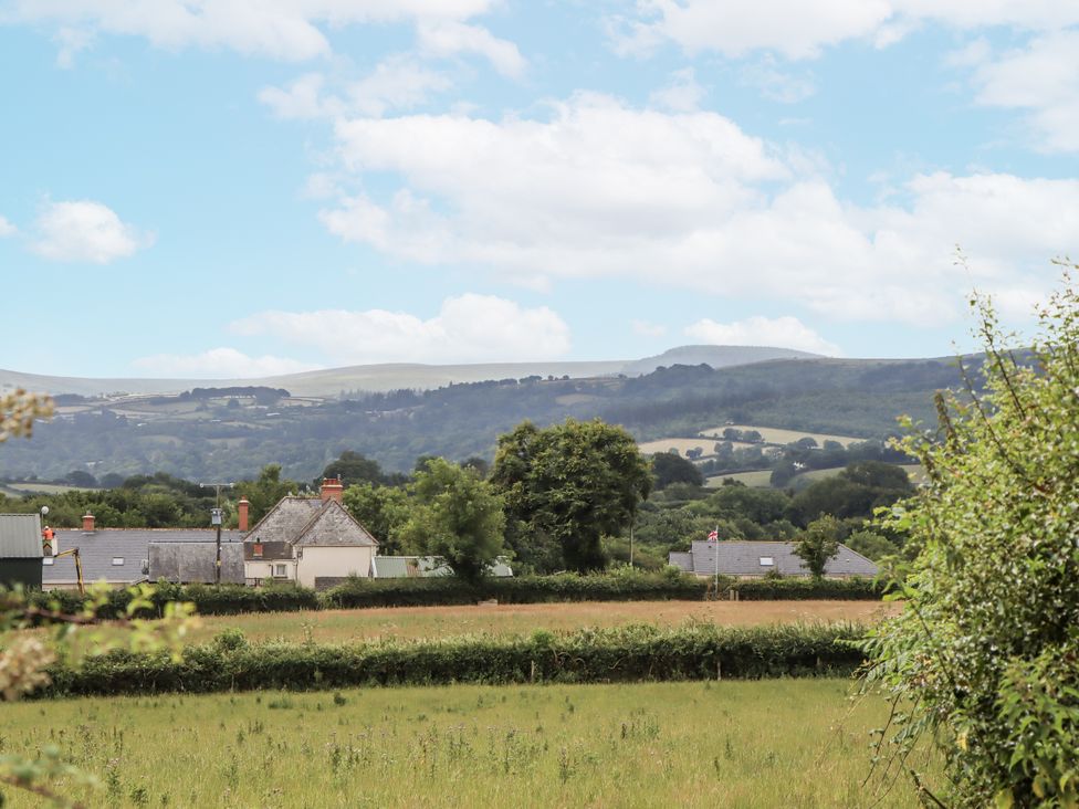 A view of houses and fields with hills in the background at Aunty Junes Cottage Okehampton