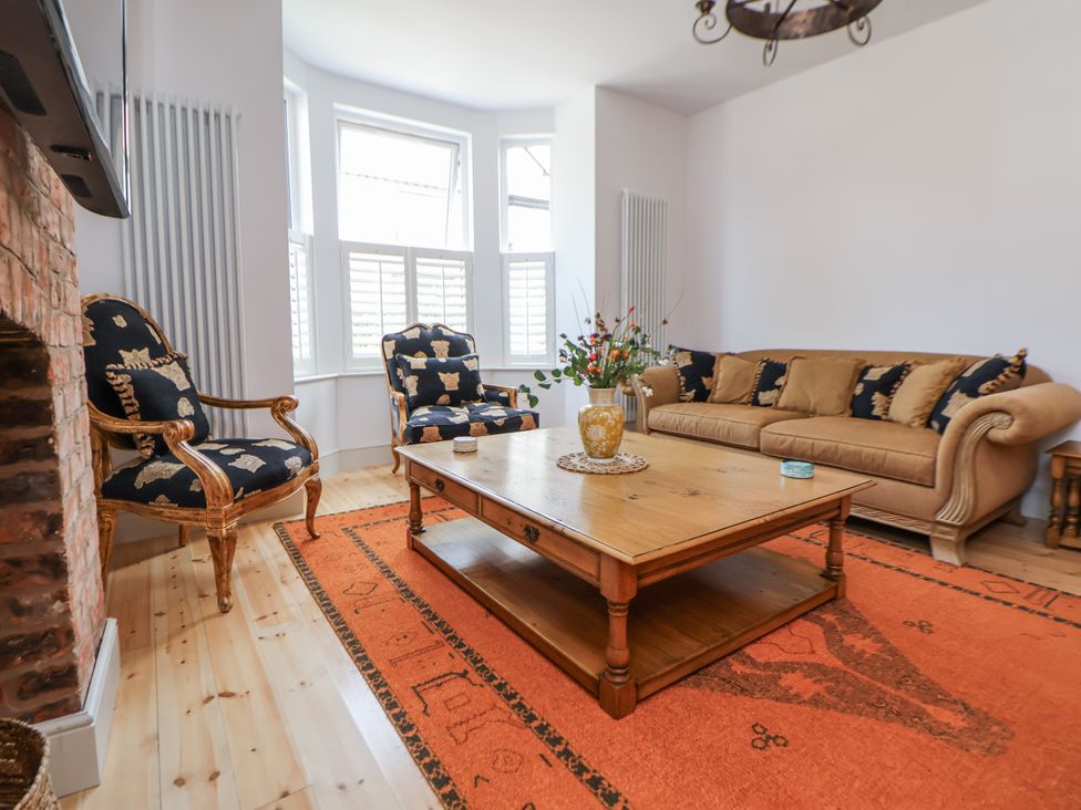 A living room with sofa and armchairs at 33 Lorne Street Chester