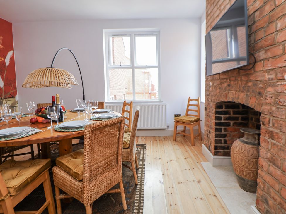 A dining room with a table set for a meal with a fireplace at 33 Lorne Street Chester