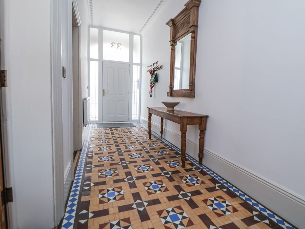 A hallway with a mirror and console table at 33 Lorne Street Chester