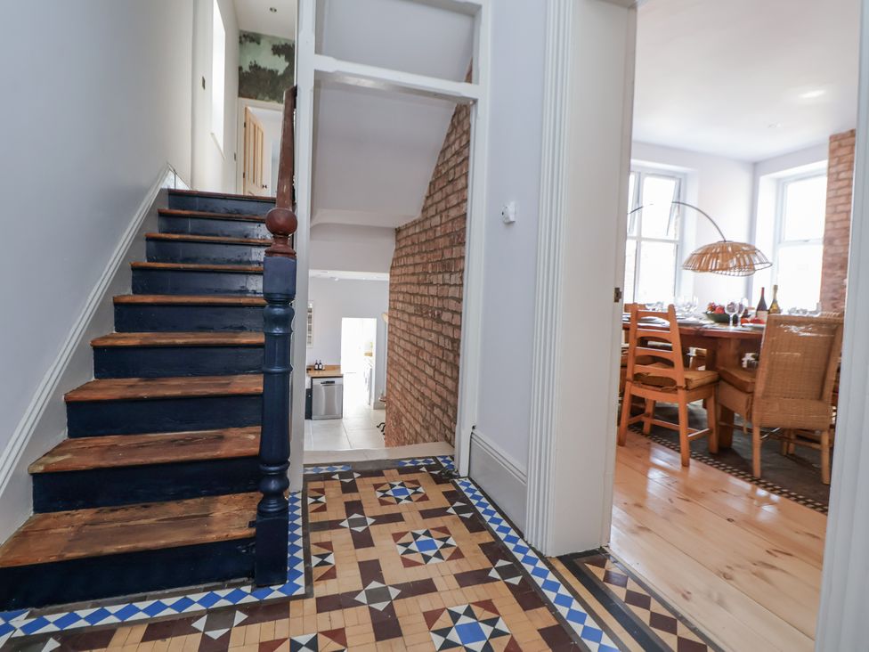 A hallway with stairs and a dining room visible at 33 Lorne Street Chester