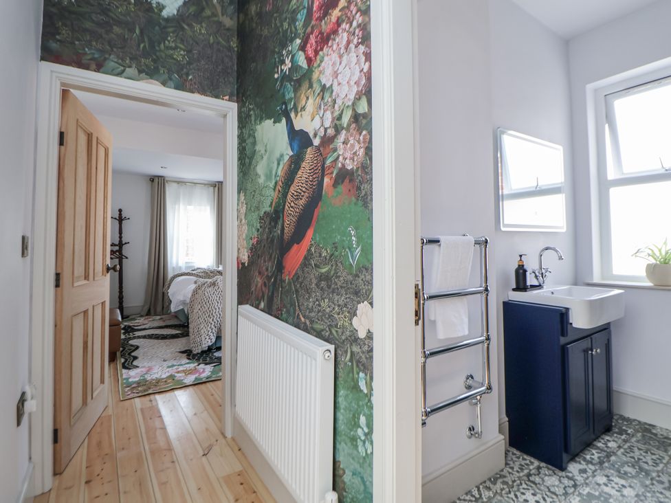 A bathroom with a sink and wall mural at 33 Lorne Street in Chester