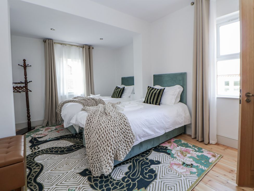A bedroom with two beds and a rug at 33 Lorne Street Chester