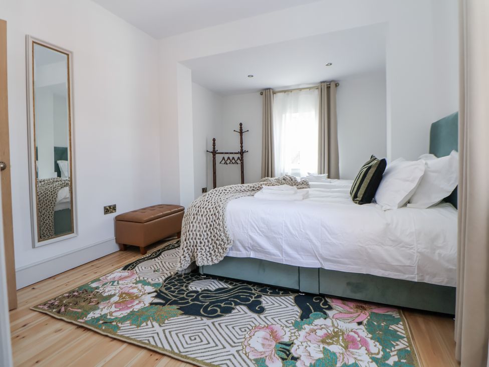 A bedroom with a bed and a mirror at 33 Lorne Street Chester