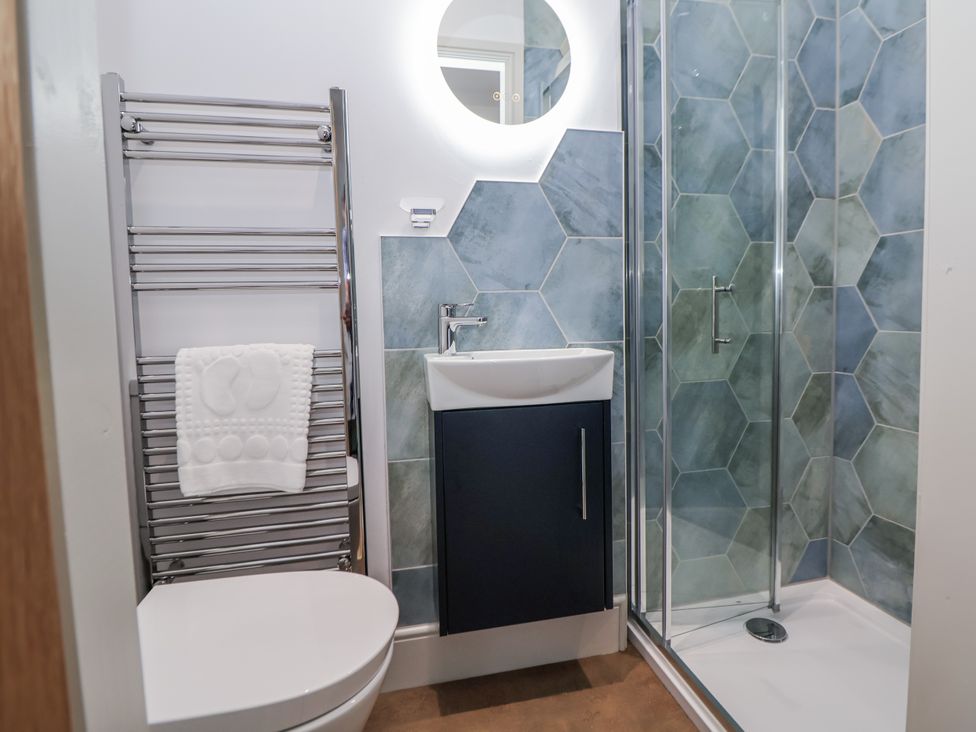 A bathroom featuring a shower, sink, and towel rack at 33 Lorne Street Chester