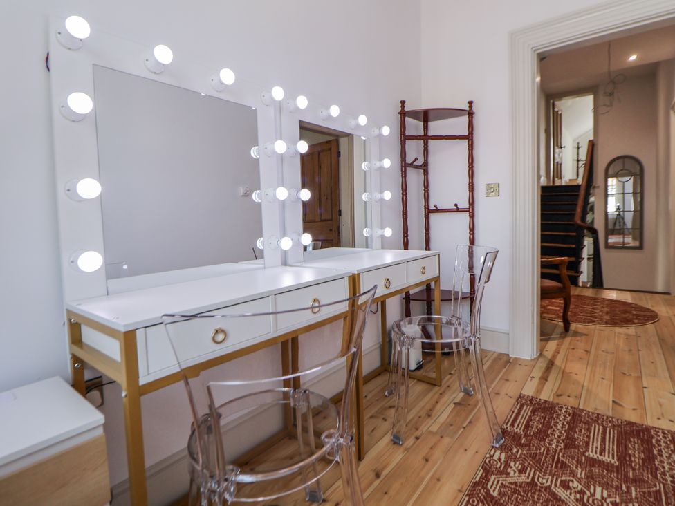 A dressing room with a makeup vanity and lights at 33 Lorne Street in Chester