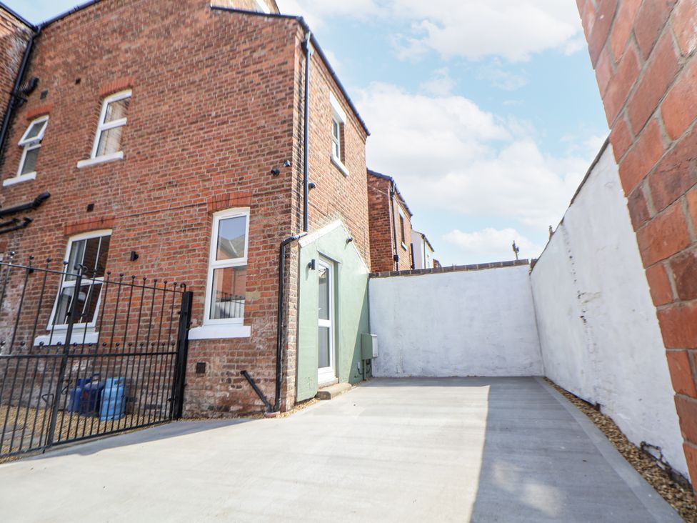 An outdoor space with a concrete area and brick walls at 33 Lorne Street Chester