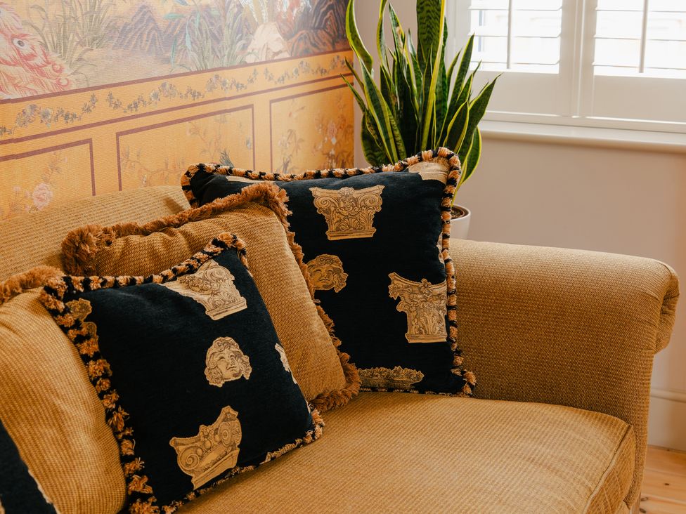 A living room with a couch and decorative pillows at 33 Lorne Street Chester