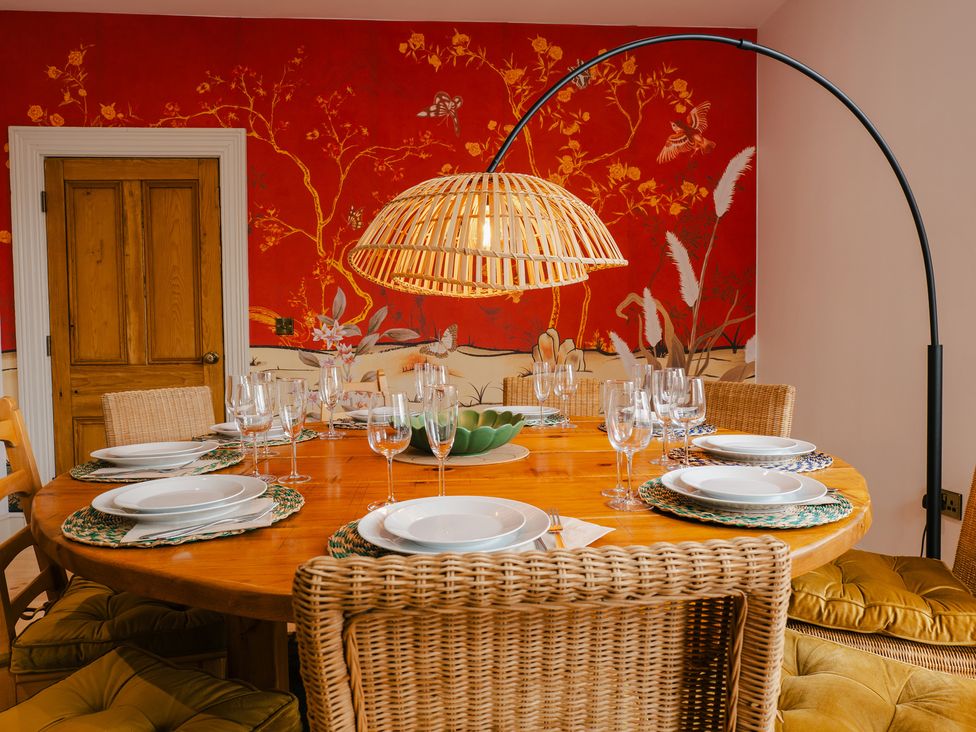 A dining room with a round table set with dishes and glassware at 33 Lorne Street Chester