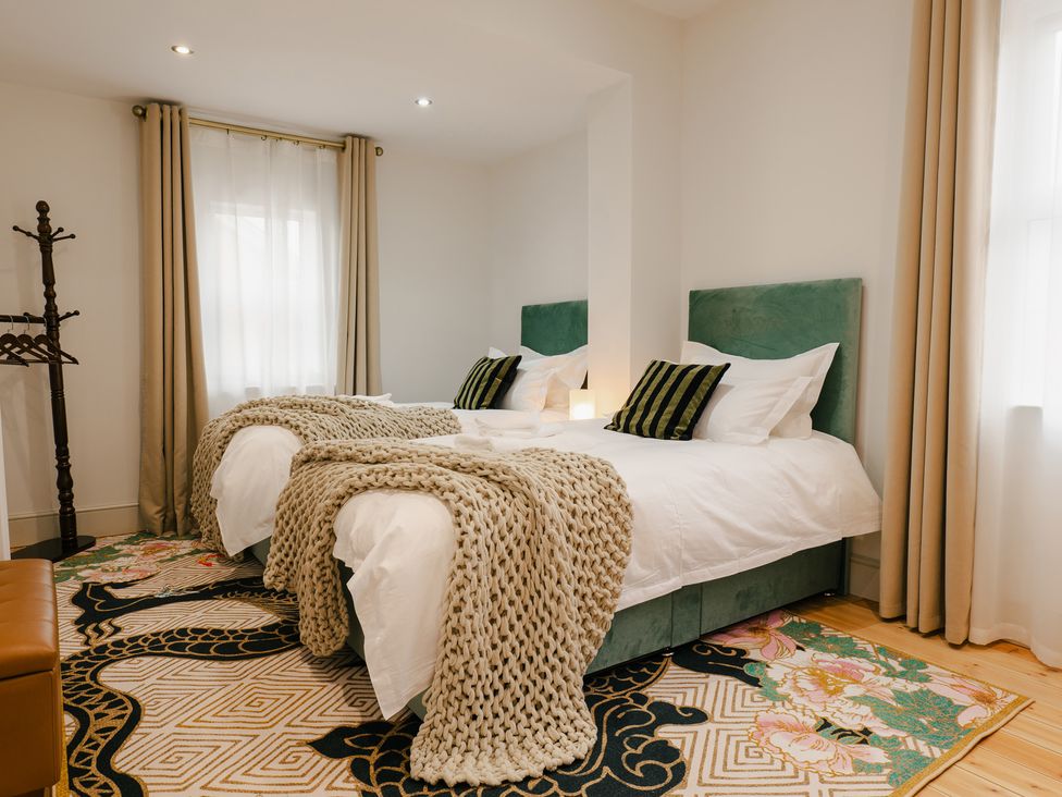 A bedroom with two beds and a wardrobe at 33 Lorne Street Chester