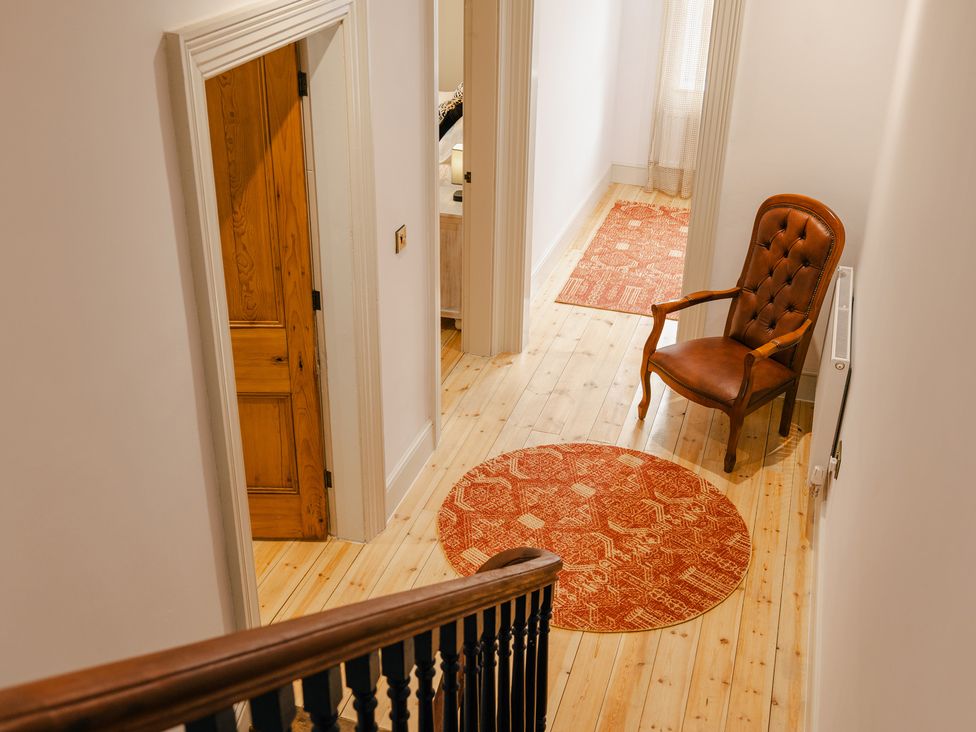 A hallway with a chair and a rug at 33 Lorne Street Chester